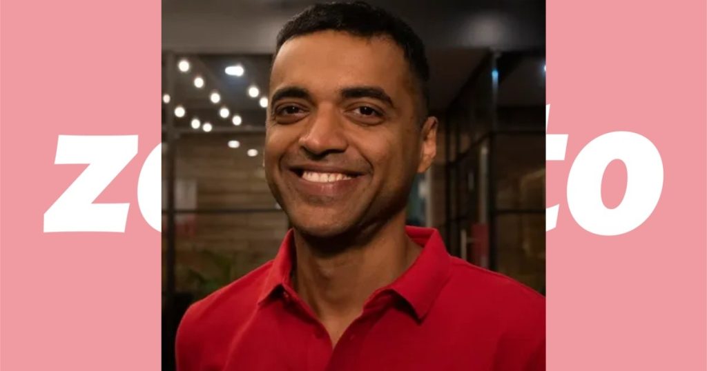 Deepinder Goyal, CEO of Zomato, speaking at an office with Zomato branding in the background