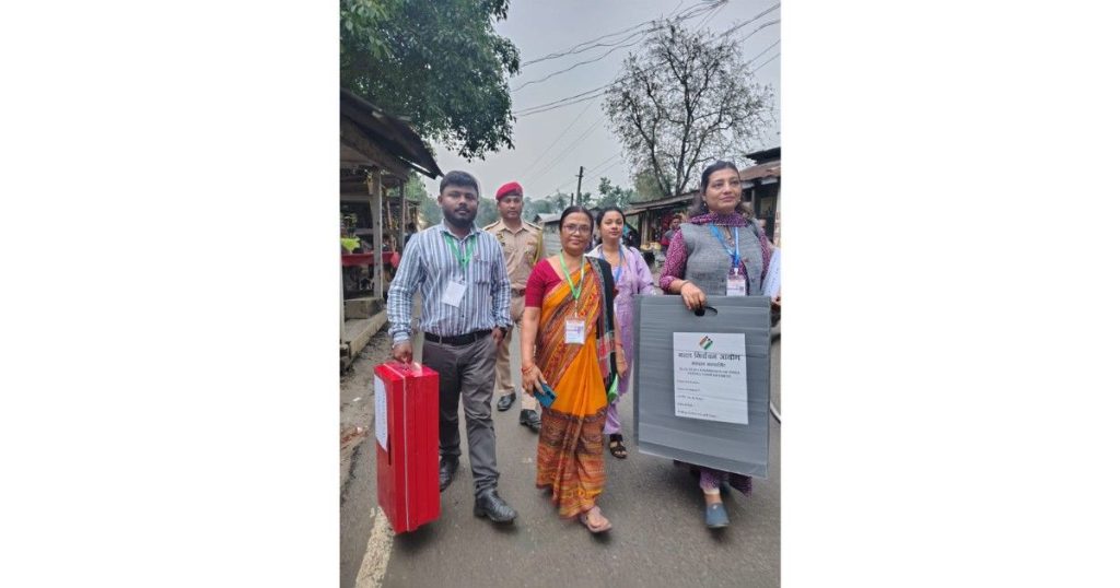 Polling personnel carrying EVMs to remote polling stations in Haflong ahead of Assam elections 2026